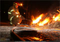 Volunteers from the Coleman Fire Department start the bonfire