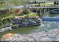 The path winds under the bridge, just downstream of Lundbreck Falls