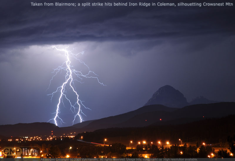 Taken from Blairmore; a split strike hits behind Iron Ridge in Coleman, silhouetting Crowsnest Mtn
